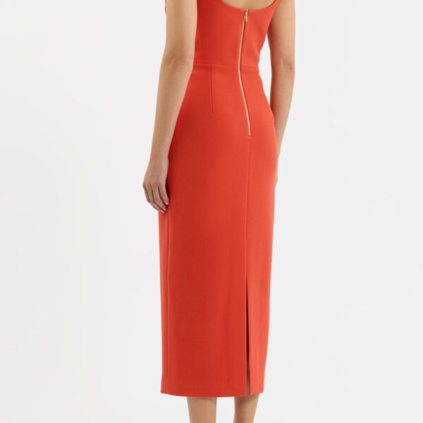 further accentuated by a cinched waist. The pencil midi skirt adds an elegant finish