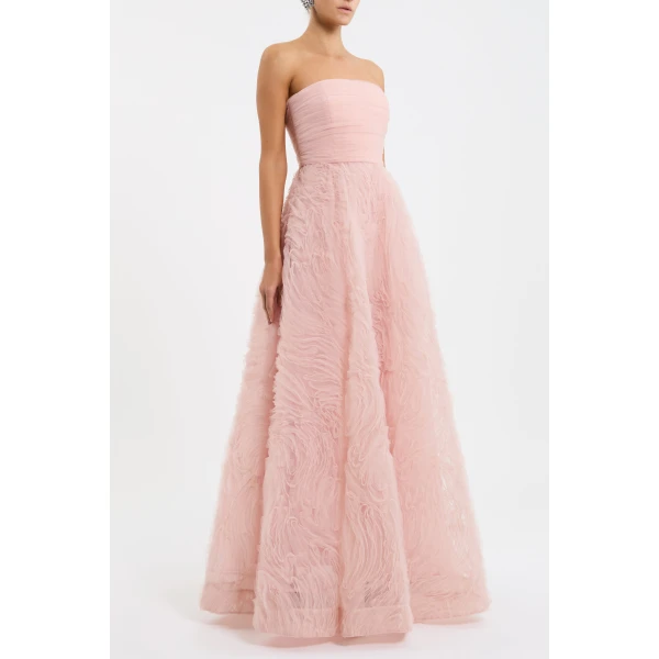 it showcases a stunning strapless neckline and a fitted bodice supported with boning. Cinched at the waist