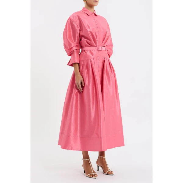 elevated by a drop waist yoke and a self-belt to define the shape. A concealed placket and side seam pockets add practicality
