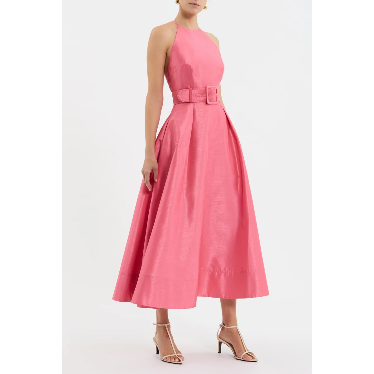 elevated by an open back and neck tie for a touch of allure. The circular midi skirt creates a graceful silhouette