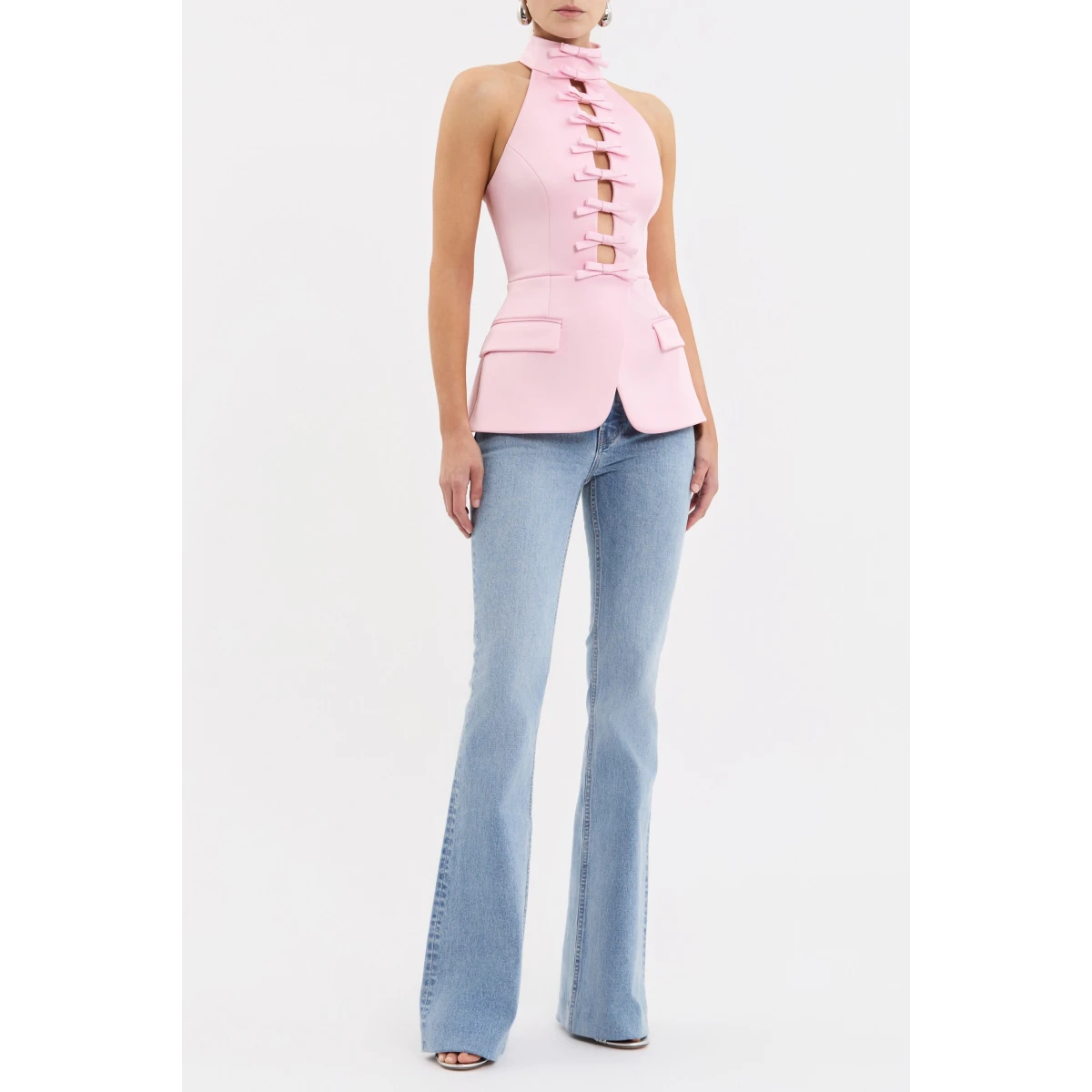 adorned with front cut-outs and bow detailing for a touch of chic style. The peplum design