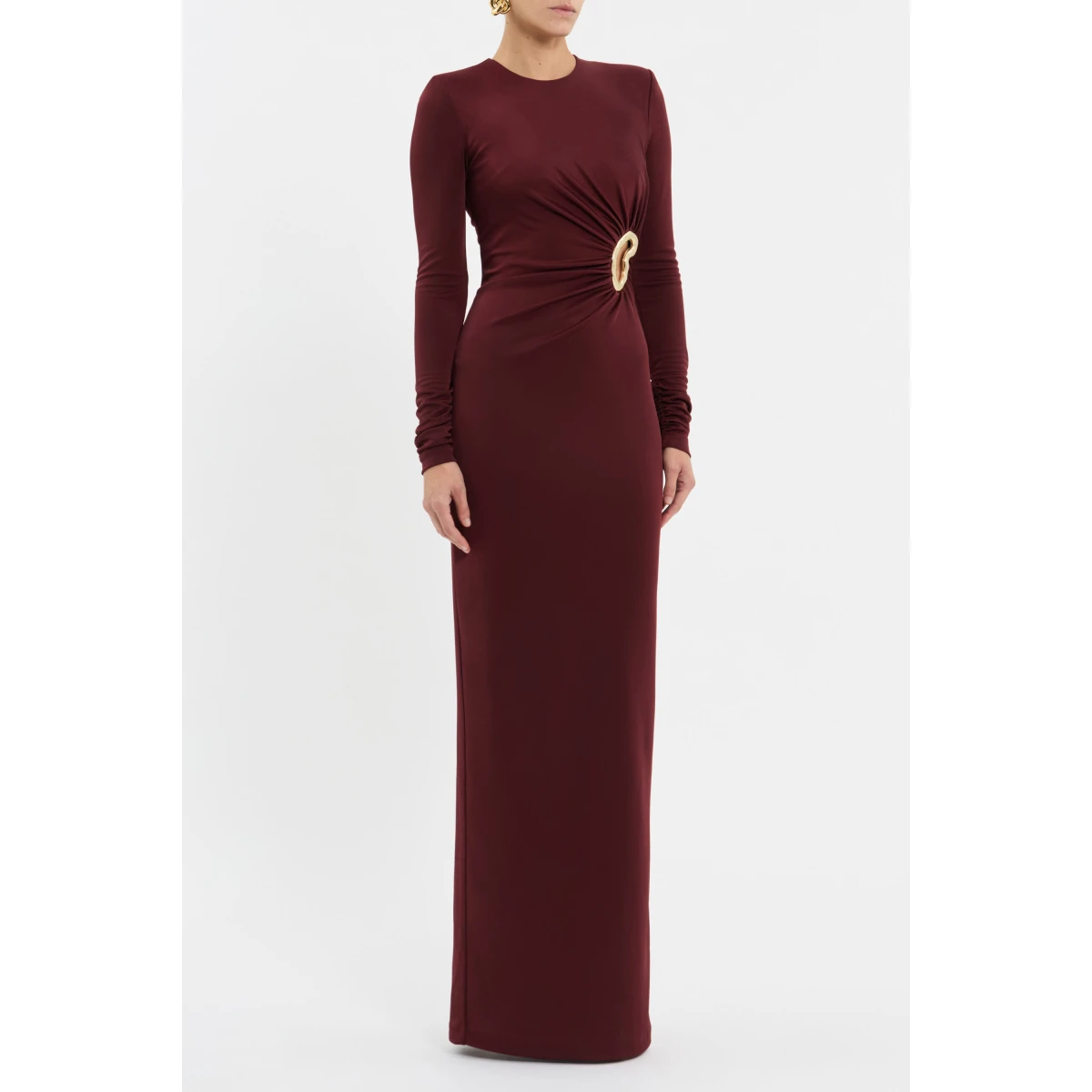 enhanced by structured shoulder pads for added definition. A side cut out and gold hardware detail add a touch of opulence and allure to the chic design. A back split in the maxi column skirt offers convenience and ease of wear