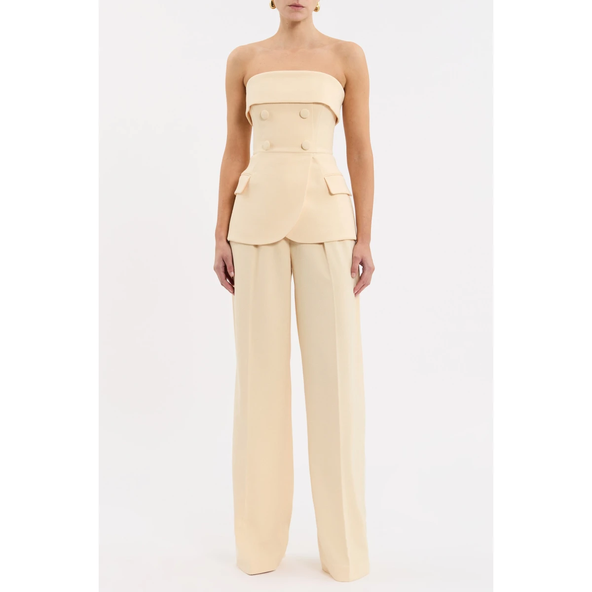 showcasing a structured suiting-inspired design. The strapless neckline and wide bust overlay beautifully complement the fitted bodice