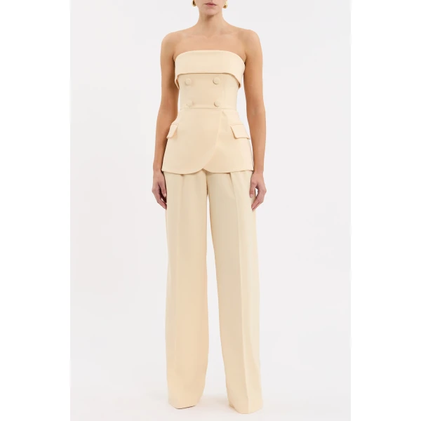 showcasing a structured suiting-inspired design. The strapless neckline and wide bust overlay beautifully complement the fitted bodice