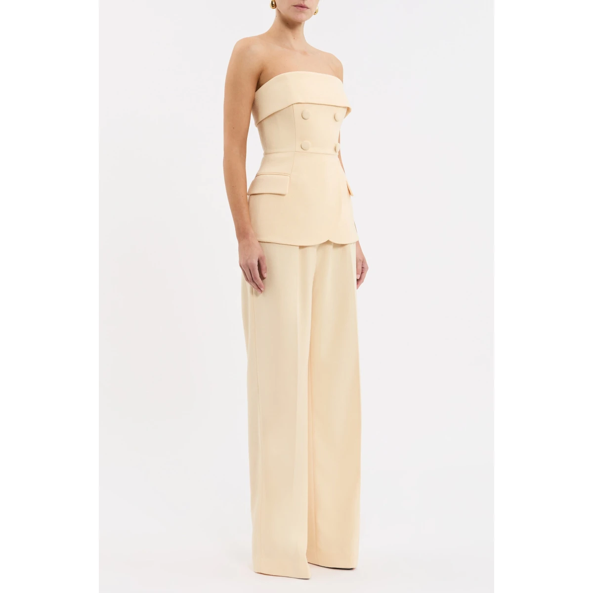 cinched at the waist to enhance the feminine figure. Button detailing and front flap pockets add a tailored touch