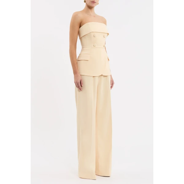 cinched at the waist to enhance the feminine figure. Button detailing and front flap pockets add a tailored touch