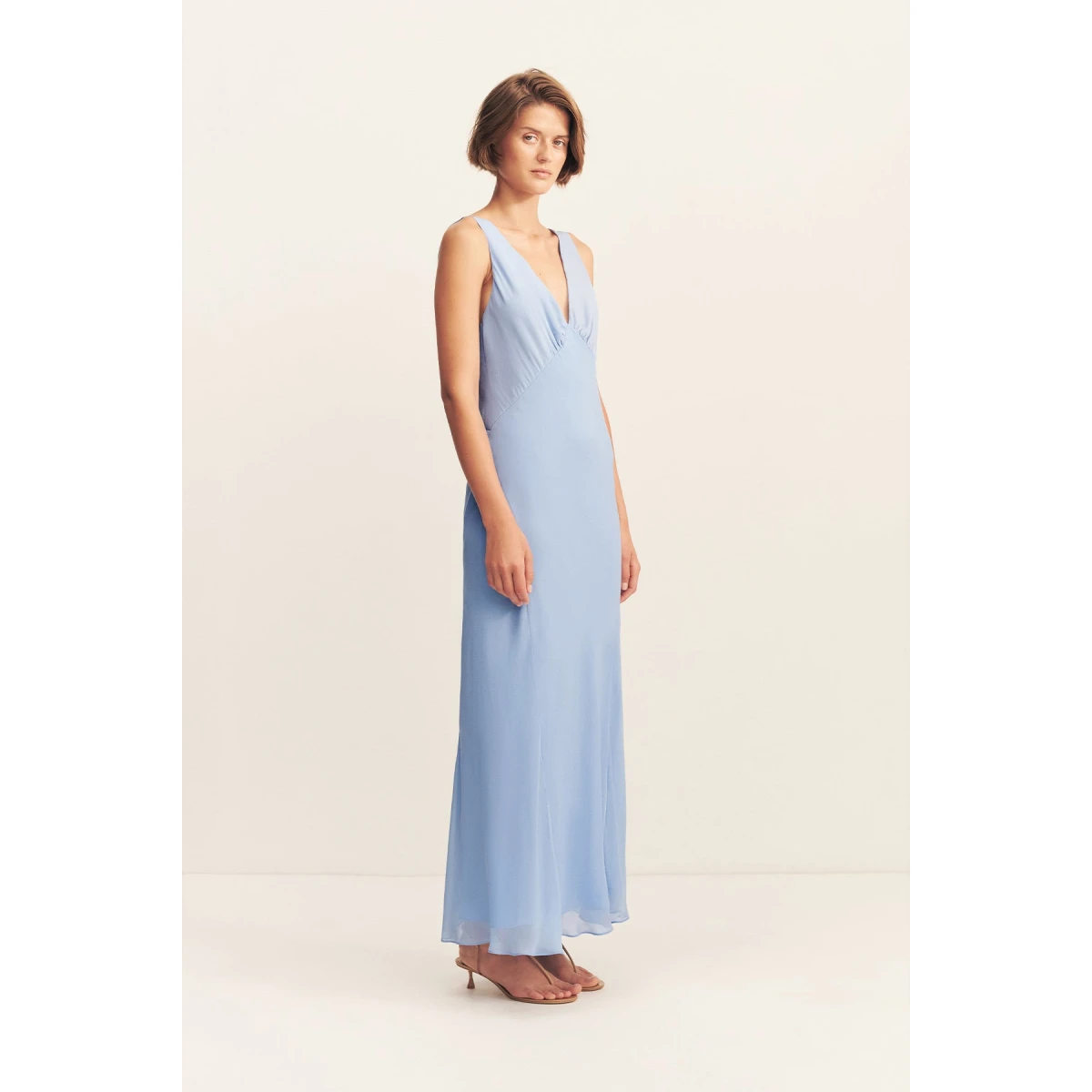 Plunged maxi dress in vista blue in a semi-sheer georgette.
