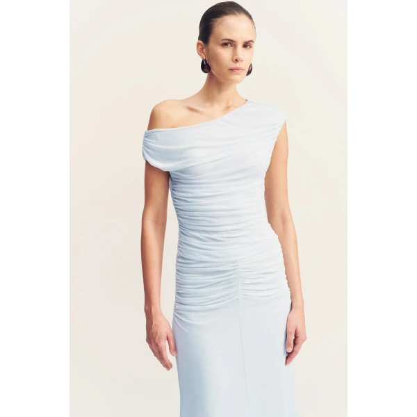 Asymmetrical off shoulder maxi dress in sky in a sheer mesh.