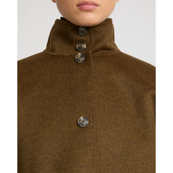 Woman wearing Yves Salomon shearling fur coat – luxury outerwear at Coveti