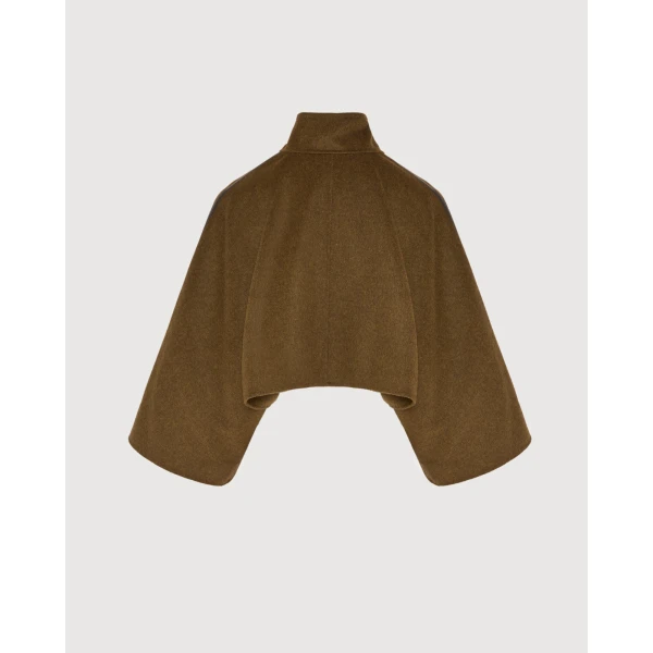 Woman wearing Yves Salomon shearling fur coat – luxury outerwear at Coveti