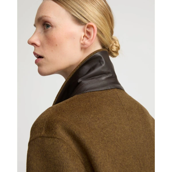 Woman wearing Yves Salomon shearling fur coat – luxury outerwear at Coveti
