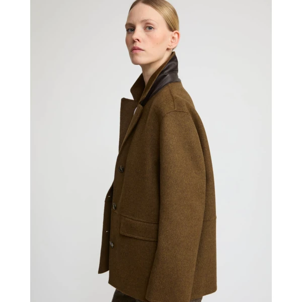 Woman wearing Yves Salomon shearling fur coat – luxury outerwear at Coveti