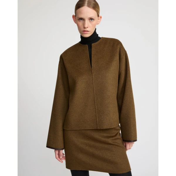Woman wearing Yves Salomon shearling fur coat – luxury outerwear at Coveti