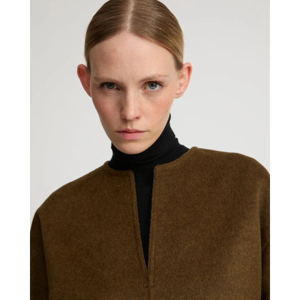 Woman wearing Yves Salomon shearling fur coat – luxury outerwear at Coveti