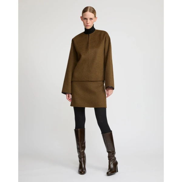 Woman wearing Yves Salomon shearling fur coat – luxury outerwear at Coveti