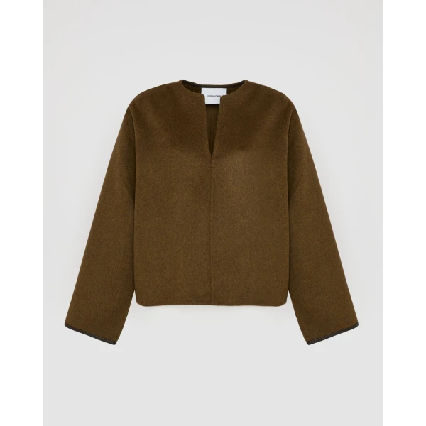 Woman wearing Yves Salomon shearling fur coat – luxury outerwear at Coveti
