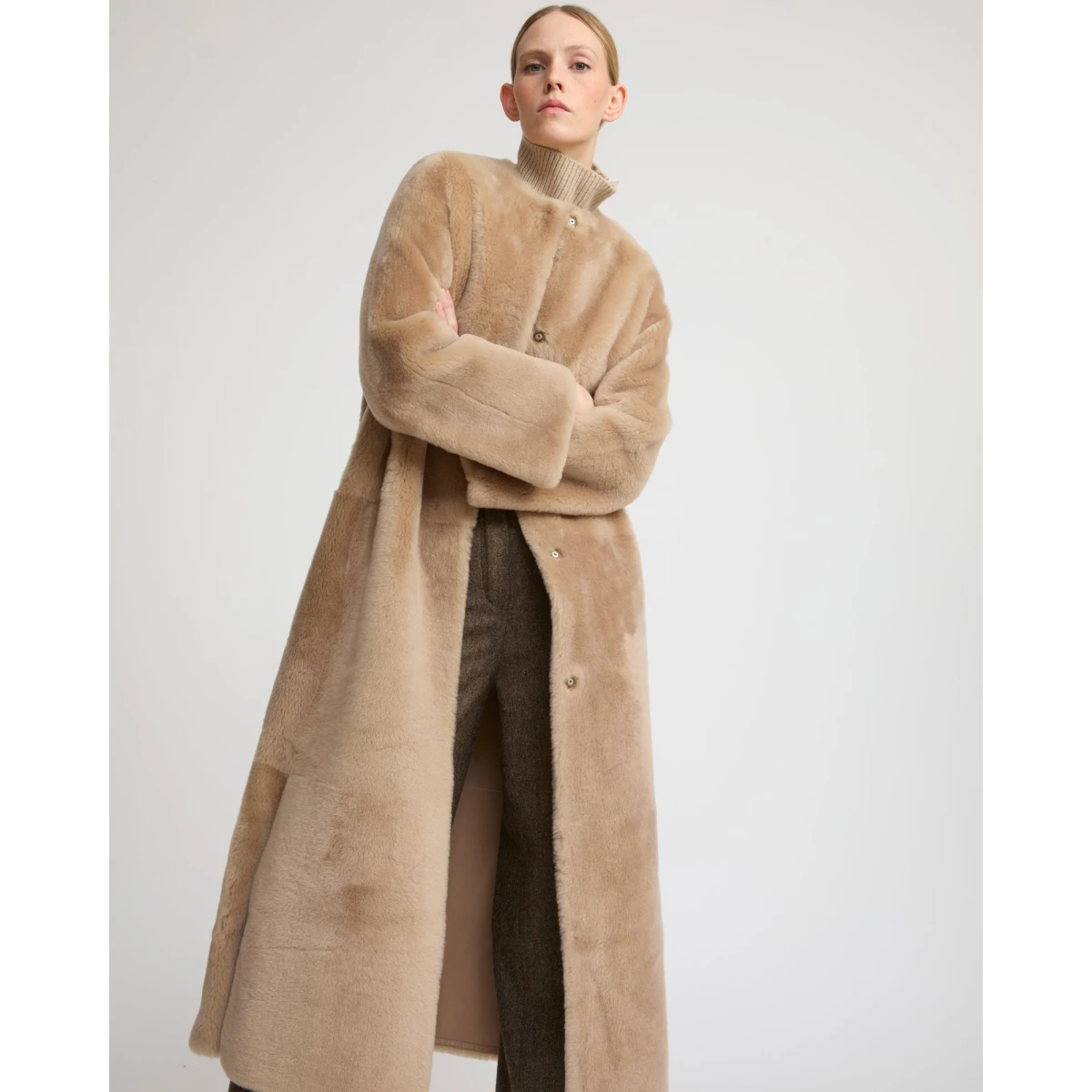 Woman wearing Yves Salomon shearling fur coat – luxury outerwear at Coveti