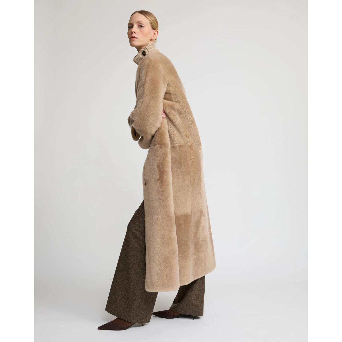 Woman wearing Yves Salomon shearling fur coat – luxury outerwear at Coveti