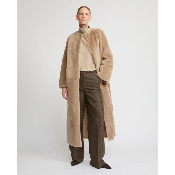 Woman wearing Yves Salomon shearling fur coat – luxury outerwear at Coveti