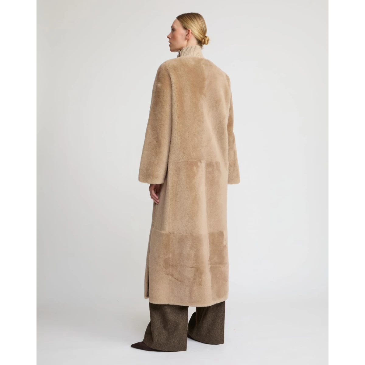 Woman wearing Yves Salomon shearling fur coat – luxury outerwear at Coveti