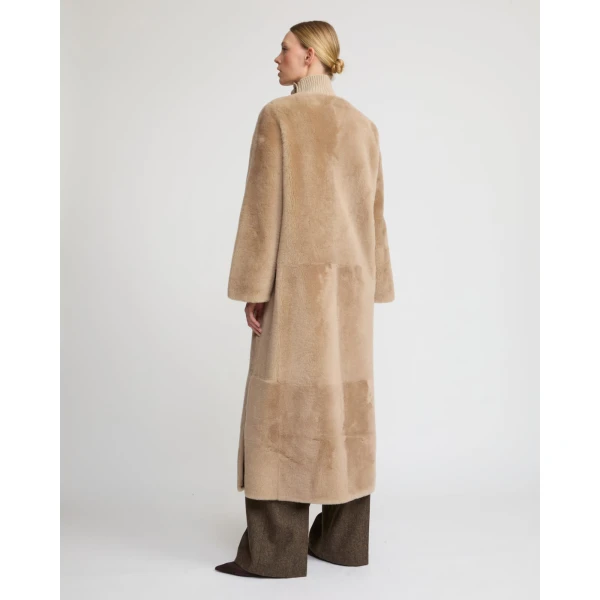 Woman wearing Yves Salomon shearling fur coat – luxury outerwear at Coveti