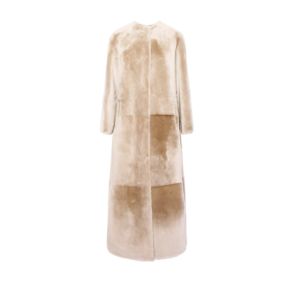 Woman wearing Yves Salomon shearling fur coat – luxury outerwear at Coveti