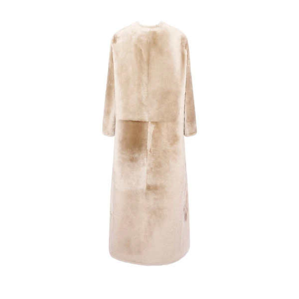 Woman wearing Yves Salomon shearling fur coat – luxury outerwear at Coveti
