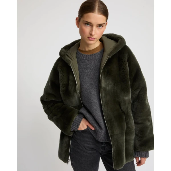 Woman wearing Yves Salomon shearling fur coat – luxury outerwear at Coveti