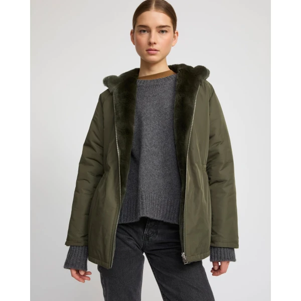 Woman wearing Yves Salomon shearling fur coat – luxury outerwear at Coveti