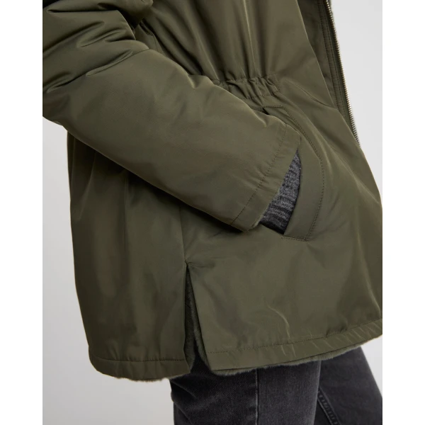 Woman wearing Yves Salomon shearling fur coat – luxury outerwear at Coveti