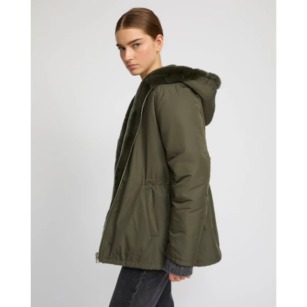 Woman wearing Yves Salomon shearling fur coat – luxury outerwear at Coveti