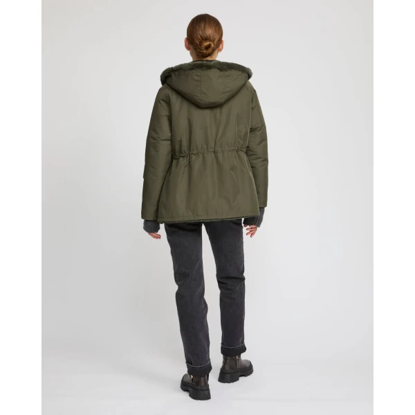 Woman wearing Yves Salomon shearling fur coat – luxury outerwear at Coveti