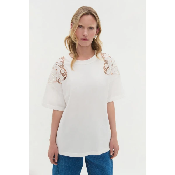 Aje Aus Tops – structured silhouette with raw femininity from Coveti