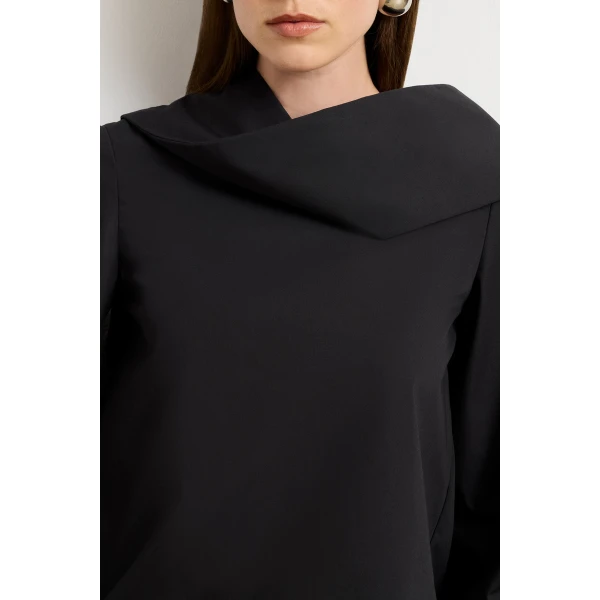 Brandon Maxwell Black Tops with sculptural silhouette photographed against minimal backdrop