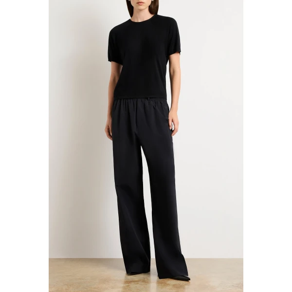 Brandon Maxwell Black Tops with sculptural silhouette photographed against minimal backdrop