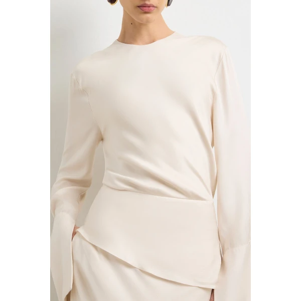 Brandon Maxwell Ivory Dresses with sculptural silhouette photographed against minimal backdrop