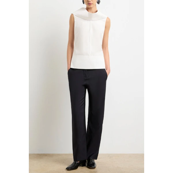 Brandon Maxwell White Tops with sculptural silhouette photographed against minimal backdrop