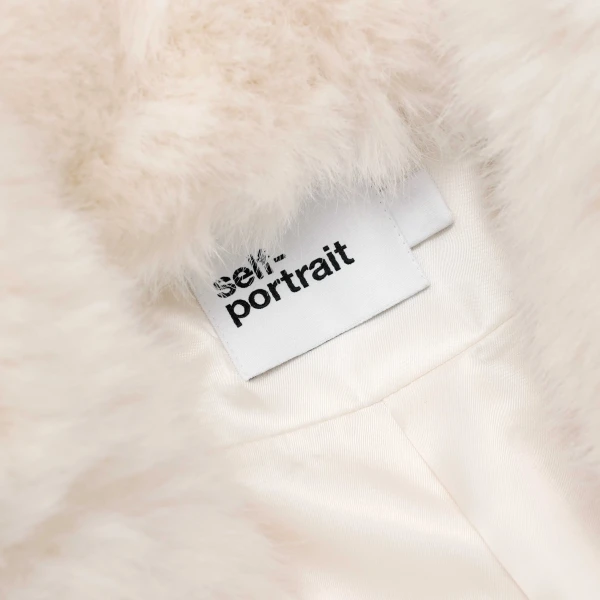 Elevate your elegance in this Self Portrait Coats  from the 2025 resort wear edit