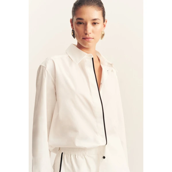 Long sleeve shirt in a white organic cotton poplin with black contrast binding.