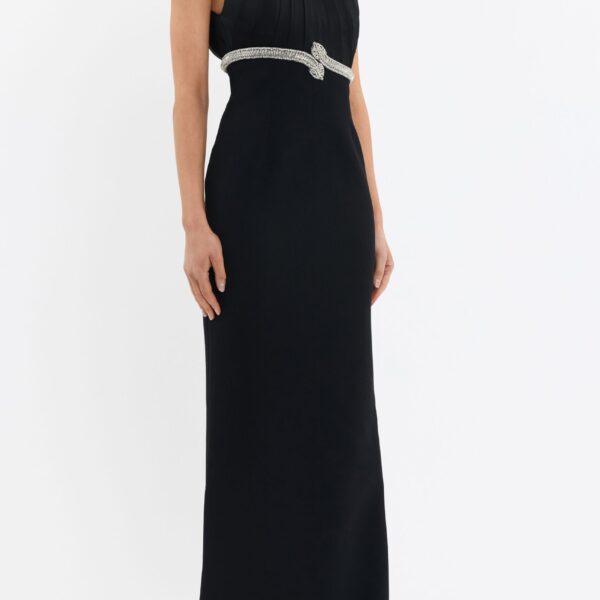 cinched at the waist to flatter the figure. The column maxi skirt is detailed with a back split for ease of movement