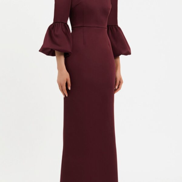 the fitted bodice seamlessly complements the crew neckline and long sleeves with puff detailing to sculpt an elegant shape. Cinched at the waist