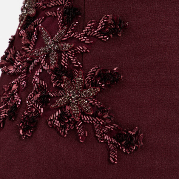 accentuated by princess seams and shoulder pads for a refined finish. Cinched at the waist