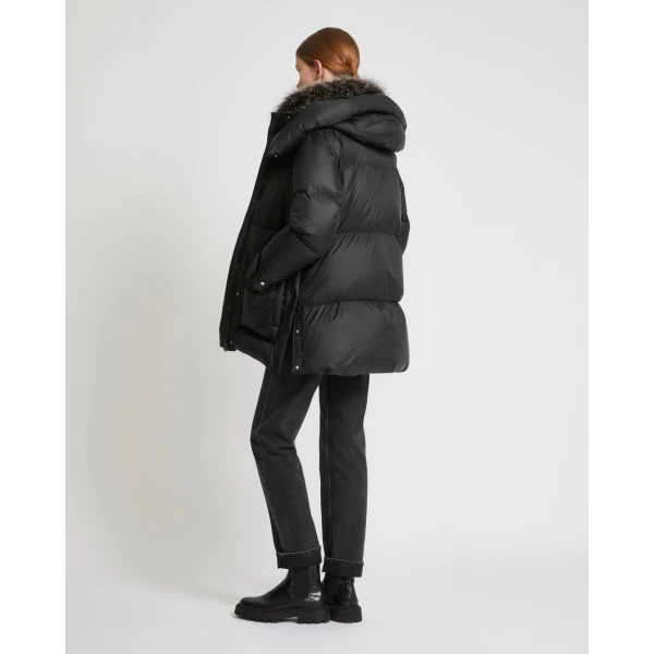 Woman wearing Yves Salomon shearling fur coat – luxury outerwear at Coveti