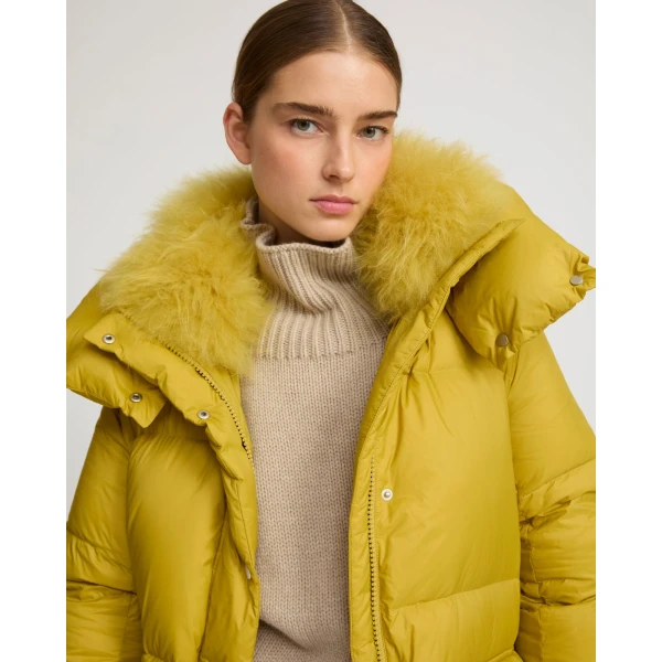 Woman wearing Yves Salomon shearling fur coat – luxury outerwear at Coveti