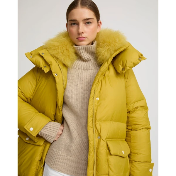 Woman wearing Yves Salomon shearling fur coat – luxury outerwear at Coveti