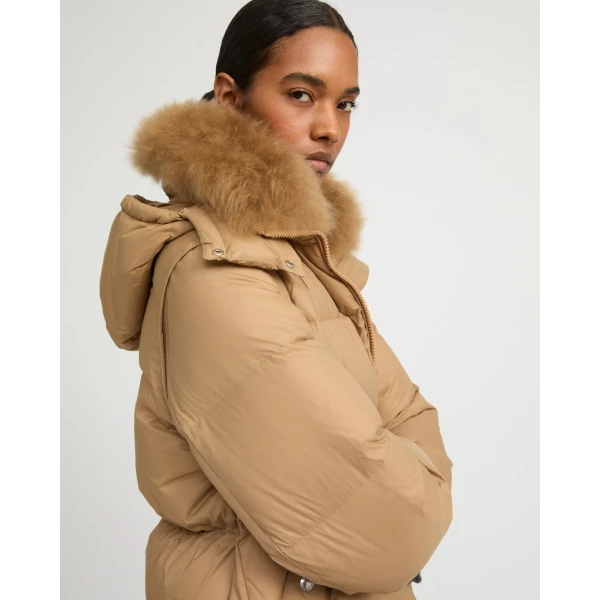 Woman wearing Yves Salomon shearling fur coat – luxury outerwear at Coveti