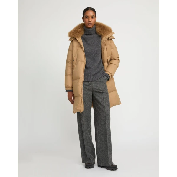 Woman wearing Yves Salomon shearling fur coat – luxury outerwear at Coveti