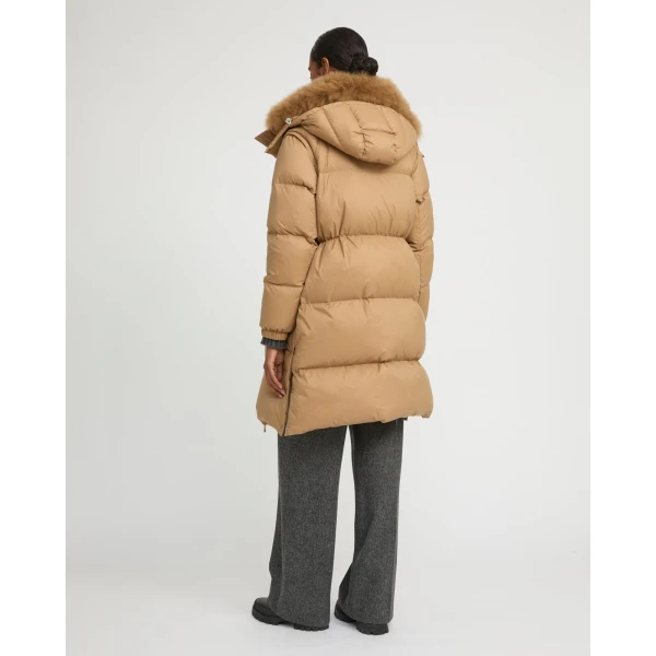 Woman wearing Yves Salomon shearling fur coat – luxury outerwear at Coveti