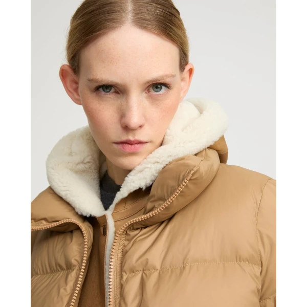 Woman wearing Yves Salomon shearling fur coat – luxury outerwear at Coveti
