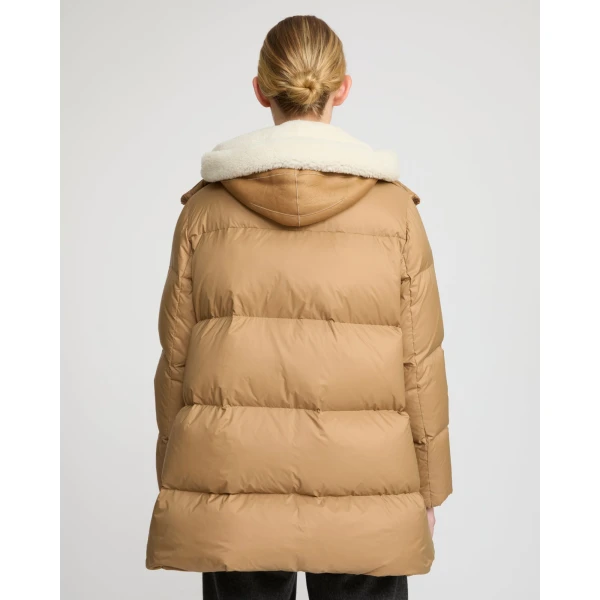 Woman wearing Yves Salomon shearling fur coat – luxury outerwear at Coveti